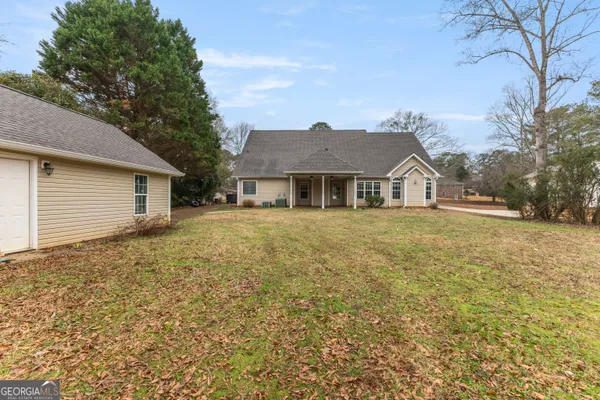 a front view of a house with a garden