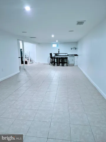 a view of a livingroom and a kitchen with furniture