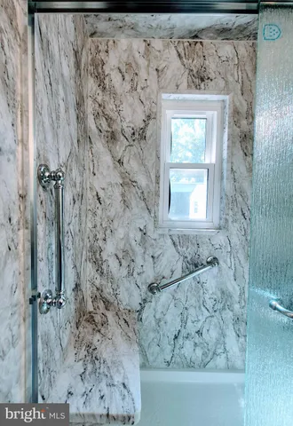 a bathroom with a bathtub and shower