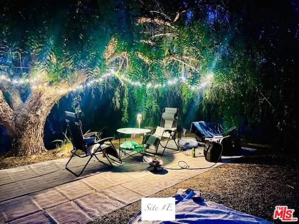 a view of a backyard with sitting area