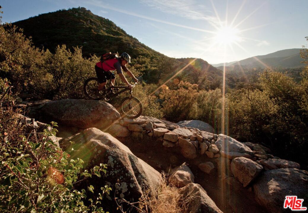 41322 De Luz Road, Unit 15 Fallbrook, CA 92028 - Photo 17 of 24 a view of a house with a backyard and a garden