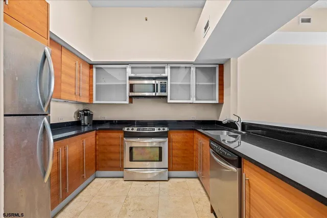 a kitchen with granite countertop a sink and a stove