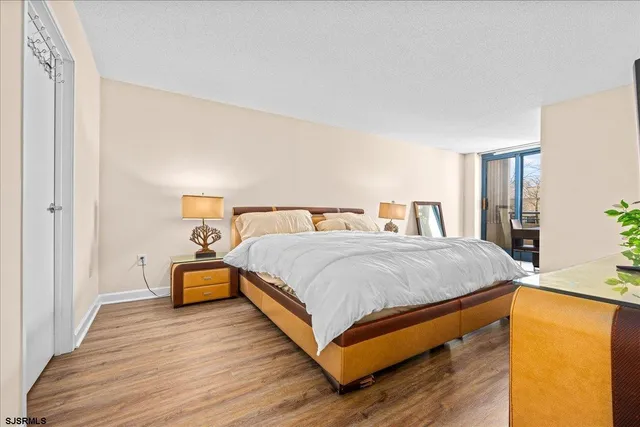 a bedroom with bed and wooden floor