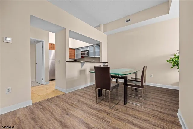 a view of a dining room with furniture and wooden floor