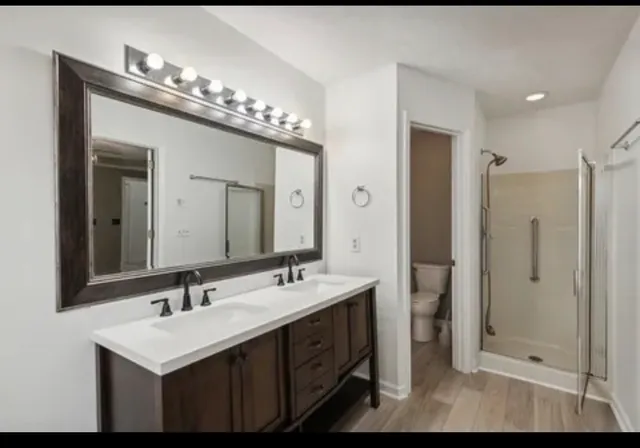 a bathroom with a sink double vanity and a mirror