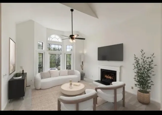 a living room with furniture a fireplace and a flat screen tv