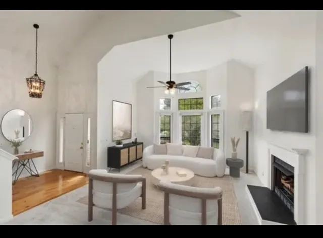 a living room with furniture a fireplace and a flat screen tv