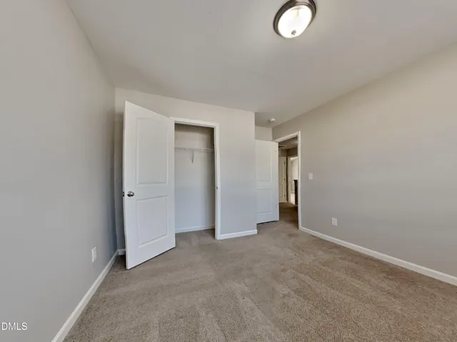 an empty room with closet area