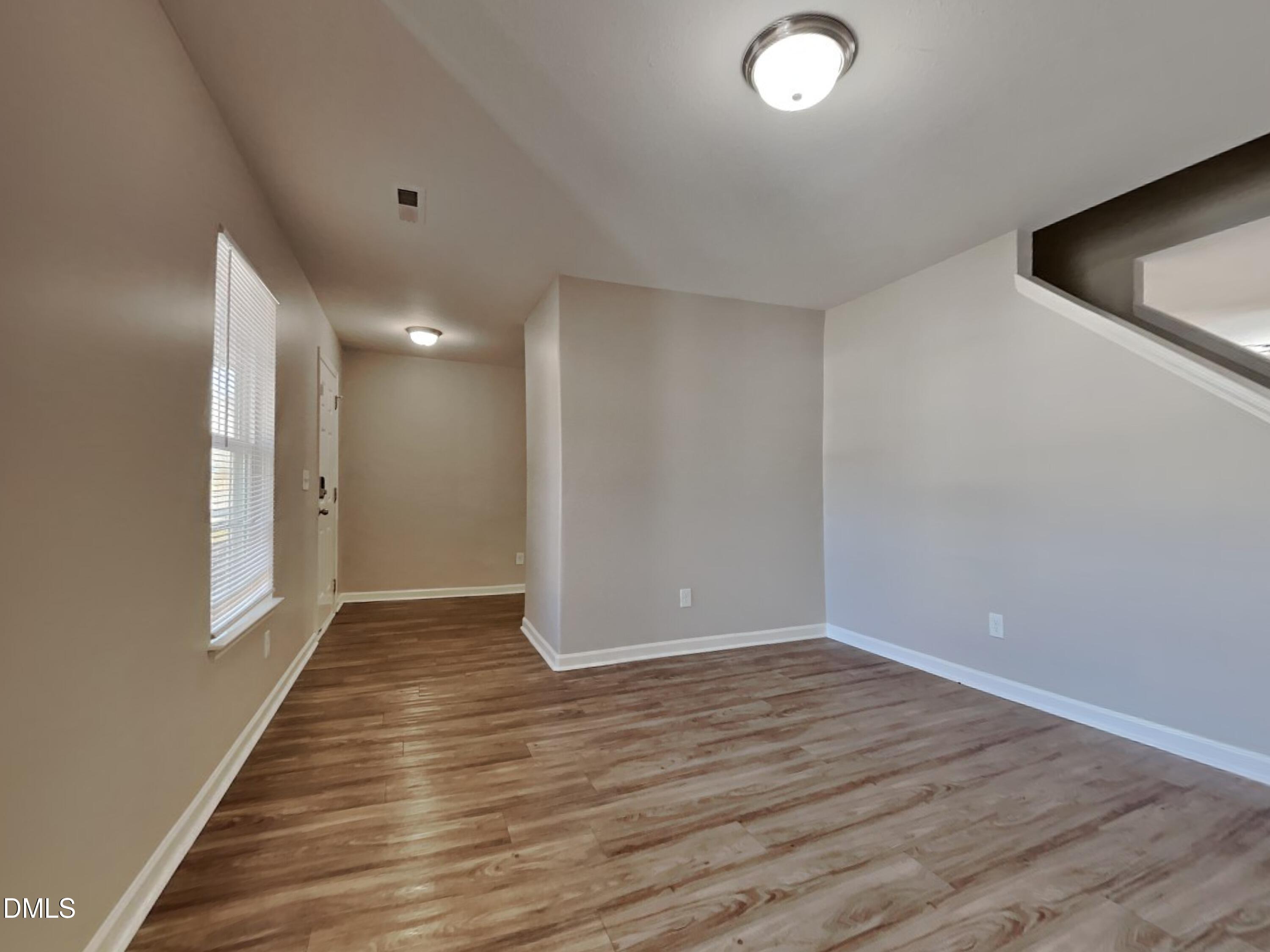 1925 Buffalo Way Durham, NC 27704 - Photo 14 of 16 a view of an empty room with wooden floor and a window
