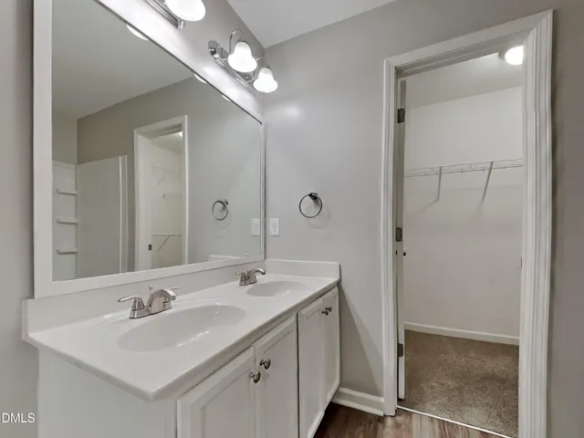 a bathroom with a sink double vanity and a mirror