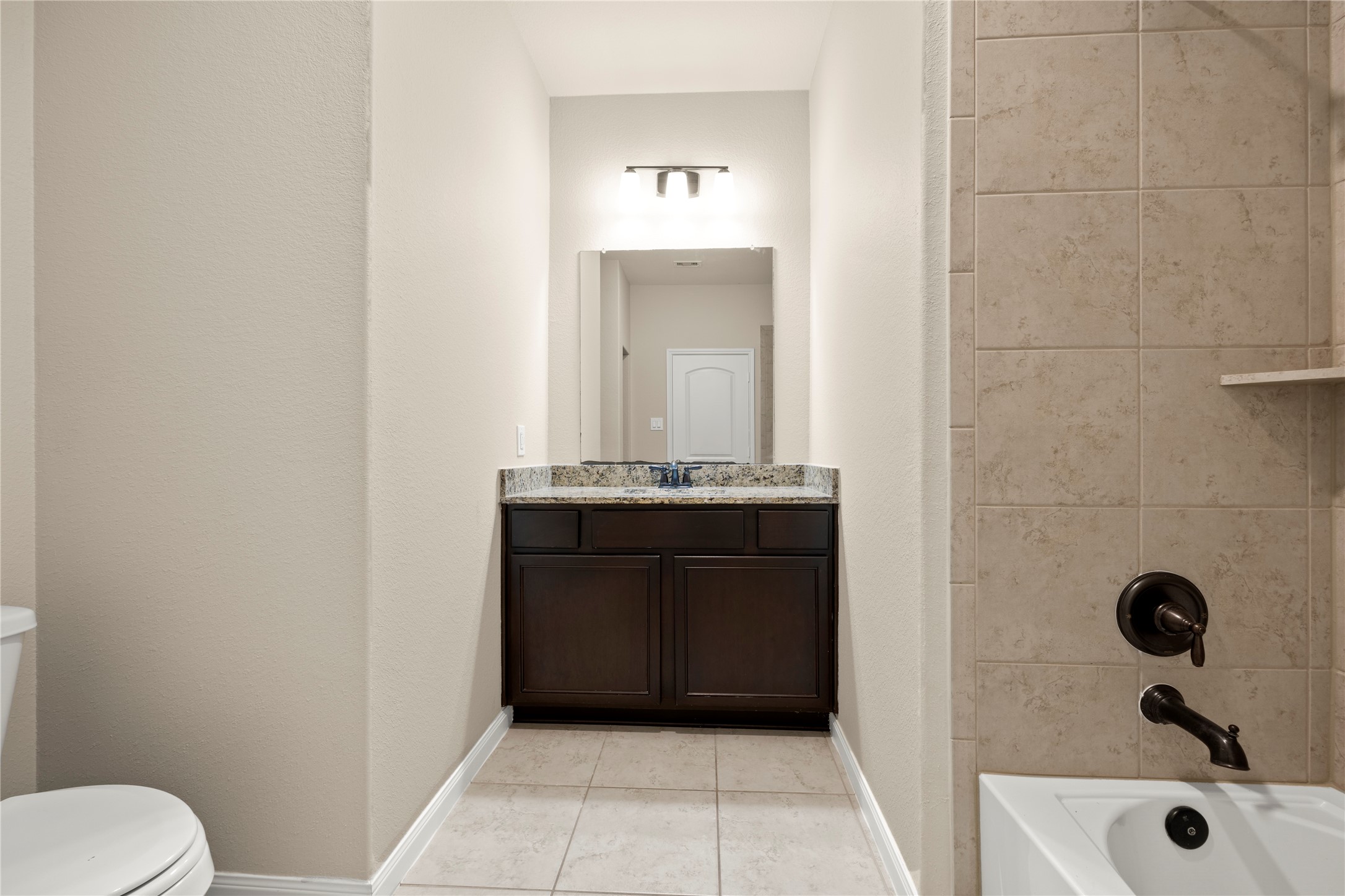 8957 Oval Glass Street Conroe, TX 77304 - Photo 11 of 30 a bathroom with a toilet