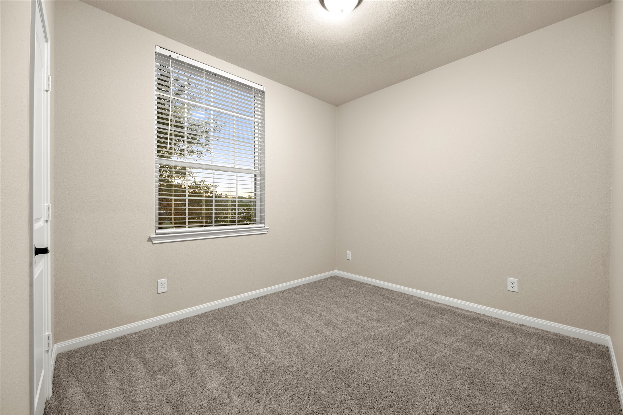 8957 Oval Glass Street Conroe, TX 77304 - Photo 13 of 30 an empty room with a window