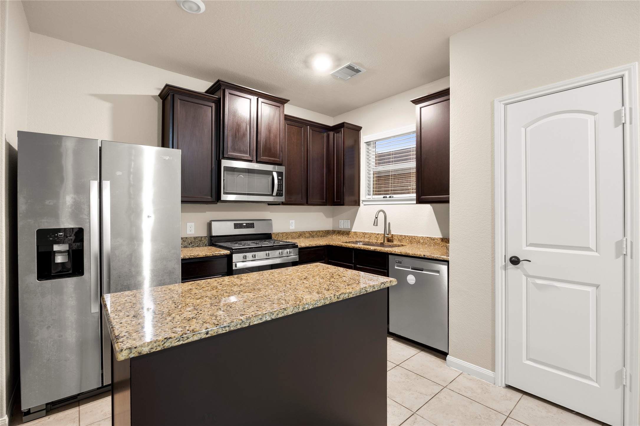 8957 Oval Glass Street Conroe, TX 77304 - Photo 16 of 30 a kitchen with granite countertop stainless steel appliances and refrigerator