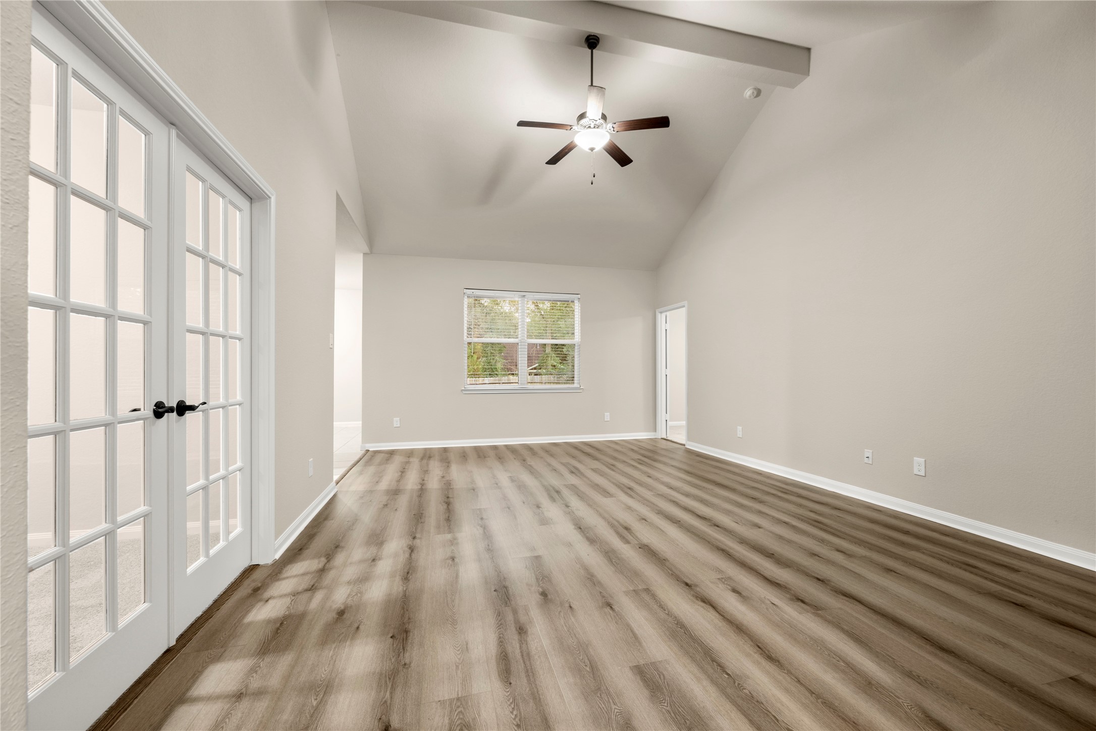 8957 Oval Glass Street Conroe, TX 77304 - Photo 5 of 30 wooden floor in an empty room with a window