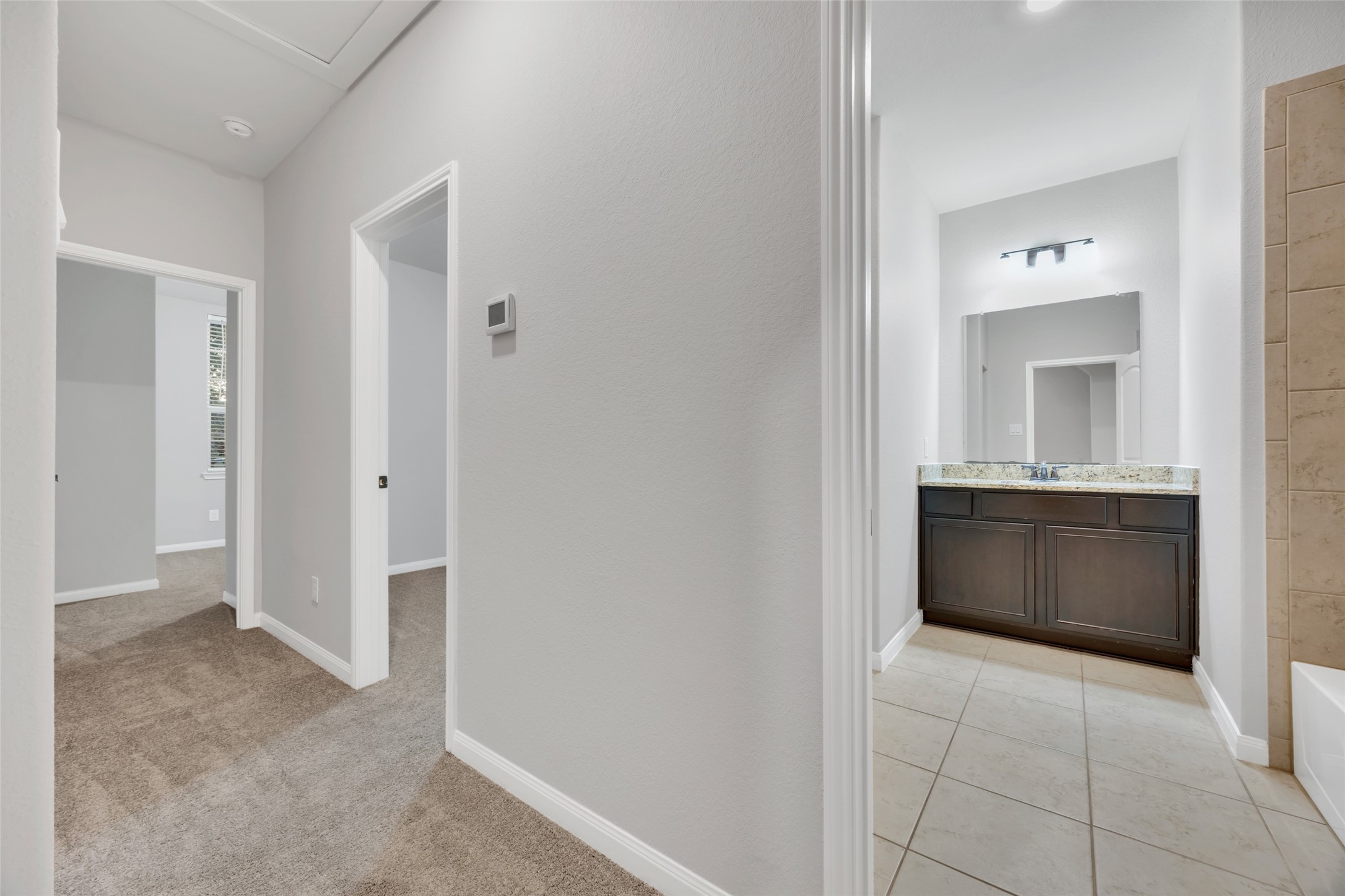 8957 Oval Glass Street Conroe, TX 77304 - Photo 10 of 30 a bathroom with a sink and a mirror