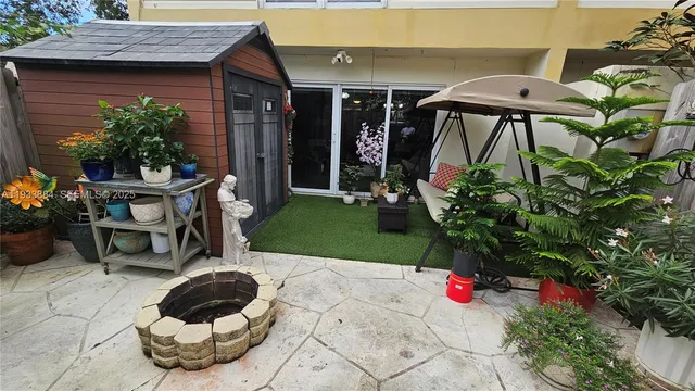 an aerial view of residential houses with outdoor space and trees