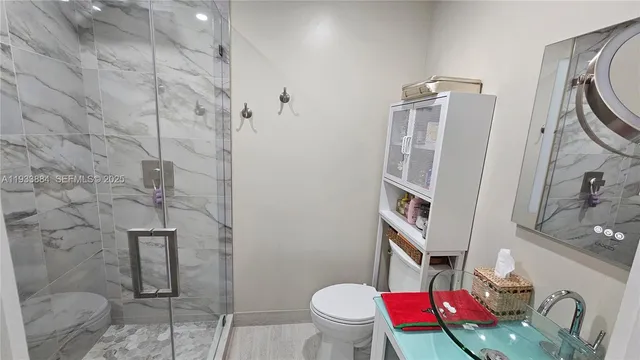 a bathroom with a sink toilet and shower