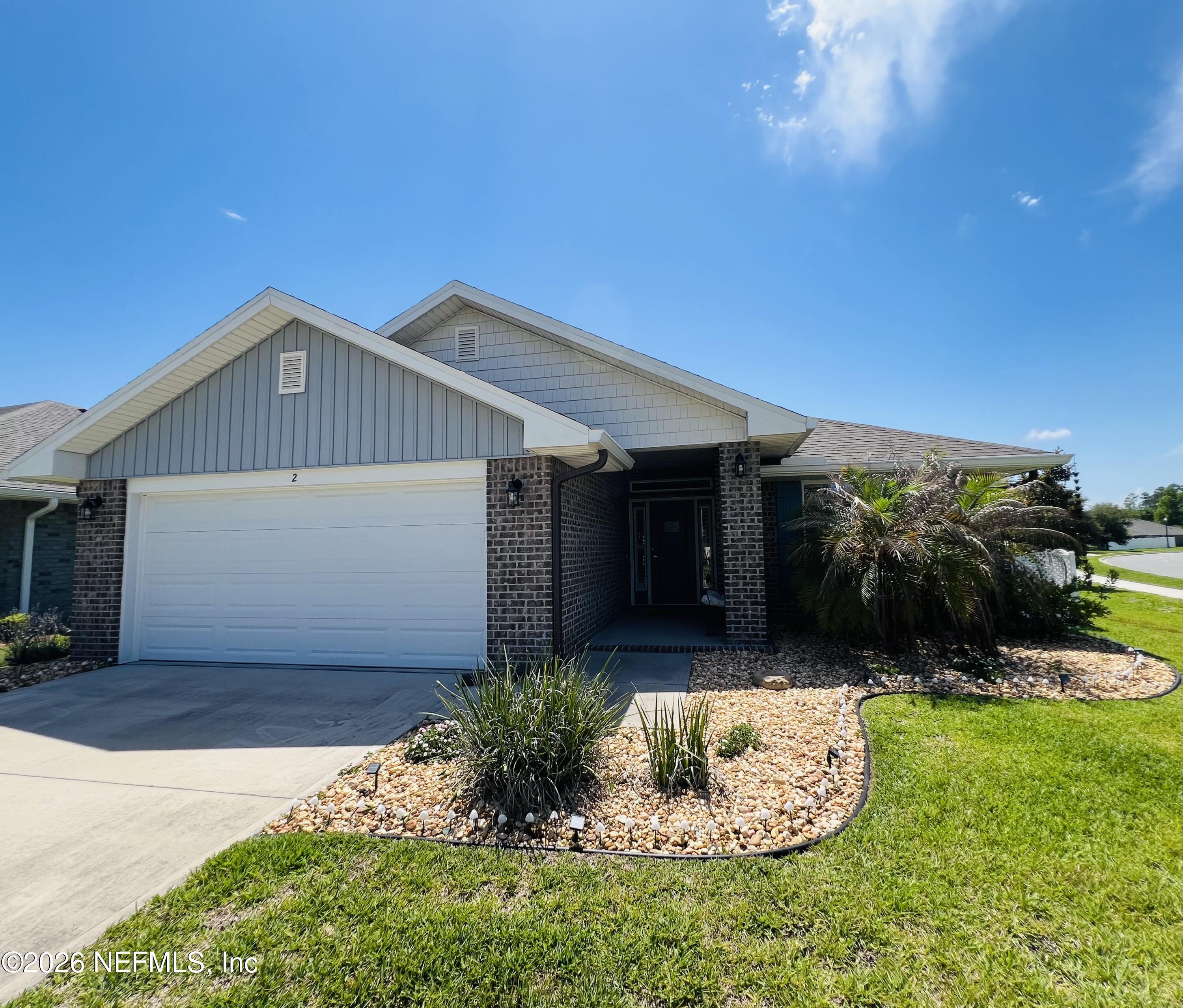 2 Rivertown Road Palm Coast, FL 32137 - Photo 15 of 80 a front view of a house with a yard