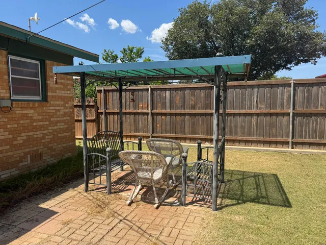 a view of a chairs and table in the patio