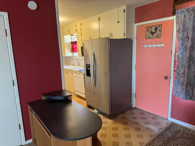 a view of a kitchen with a refrigerator and a stove