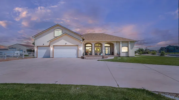 a front view of a house with a yard and garage