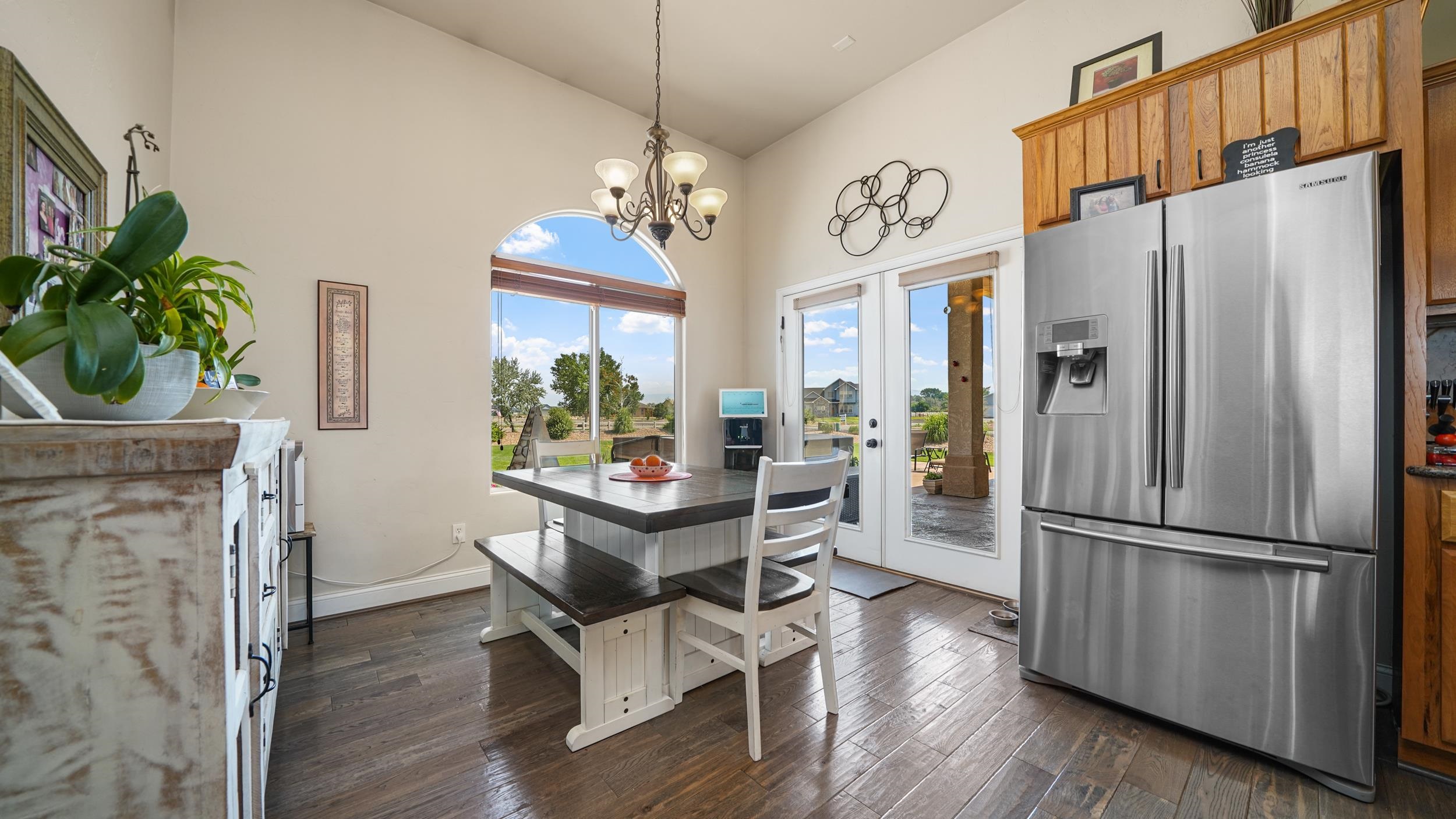 809 Mease Road Grand Junction, CO 81505 - Photo 11 of 38 a kitchen with stainless steel appliances a refrigerator a stove a sink and a dining table with wooden floor