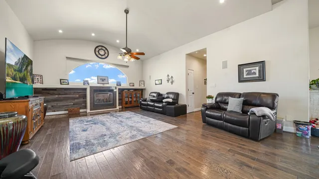 a living room with furniture kitchen view and a fireplace