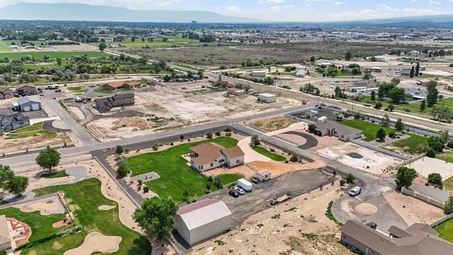 an aerial view of multiple houses with yard