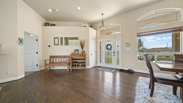 an empty room with wooden floor and outdoor seating