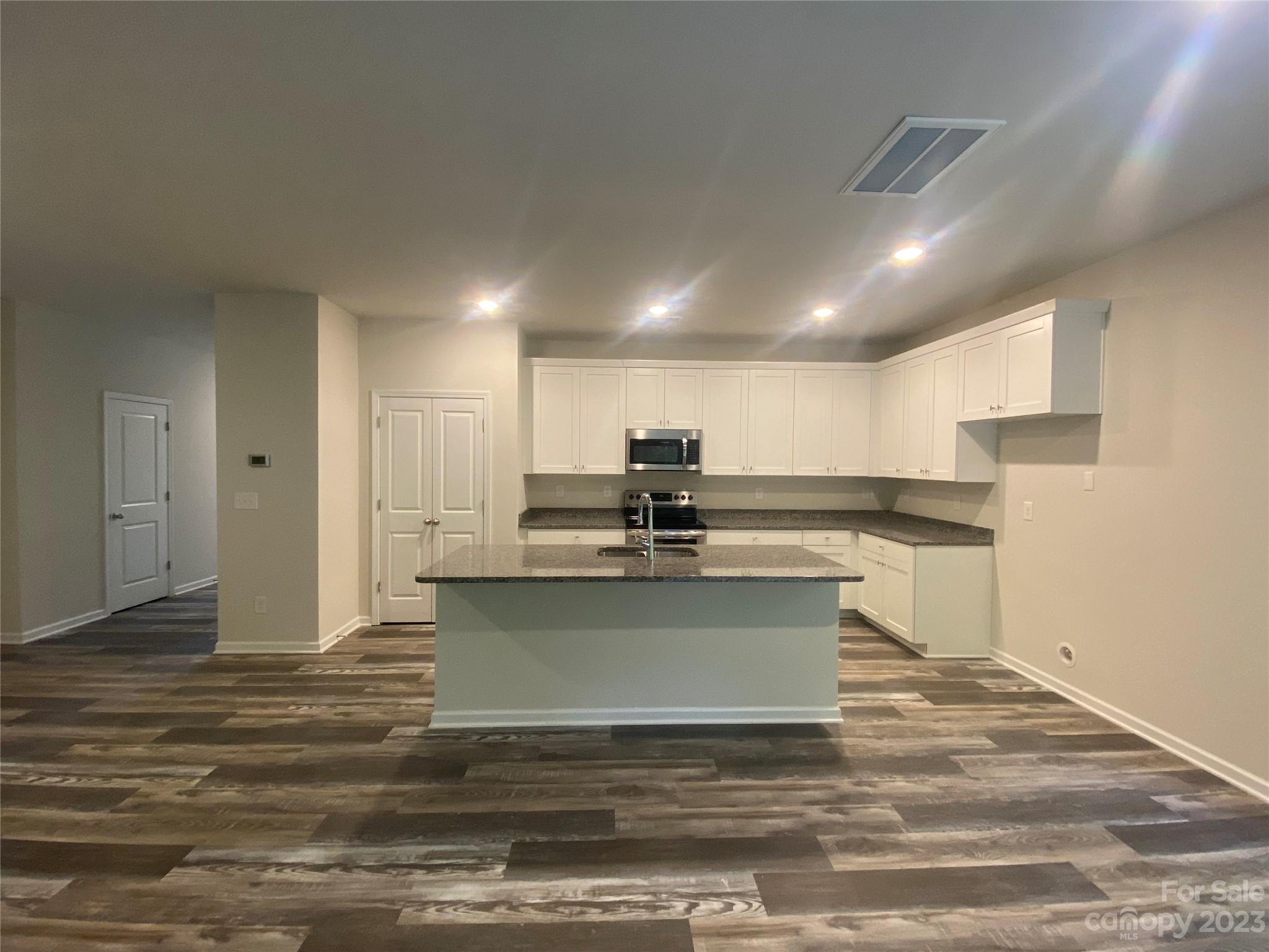 2903 Allen Road South Charlotte, NC 28269 - Photo 2 of 12 a view of kitchen with kitchen island sink refrigerator and white cabinets