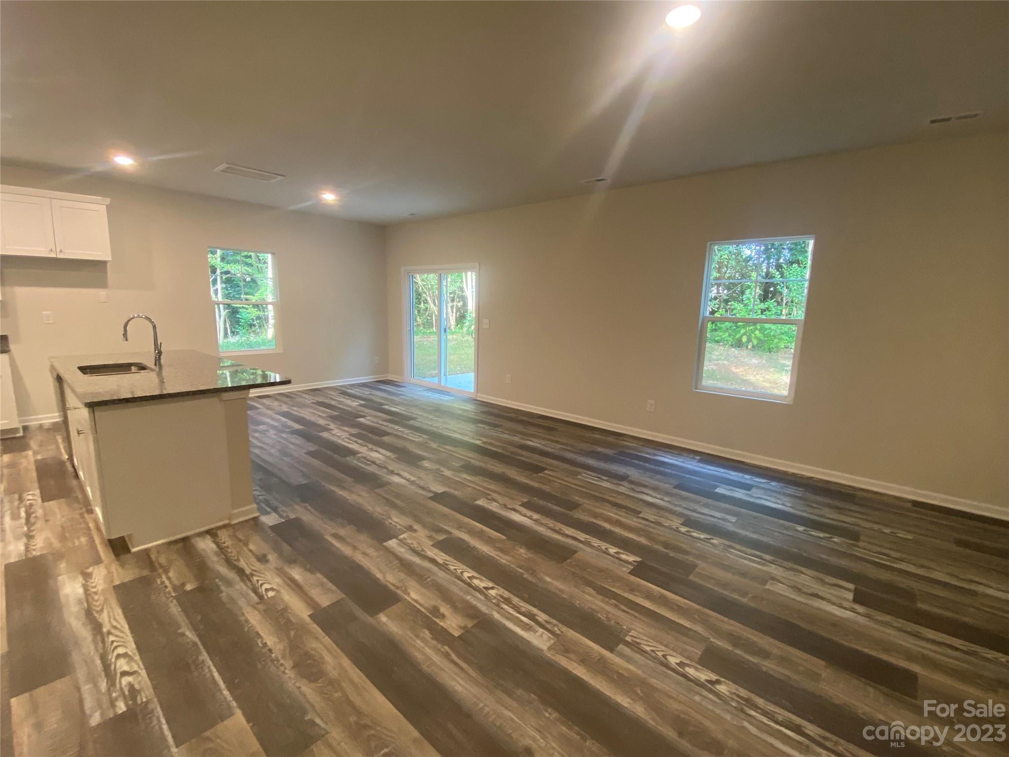 2903 Allen Road South Charlotte, NC 28269 - Photo 3 of 12 a view of an empty room with window and wooden floor