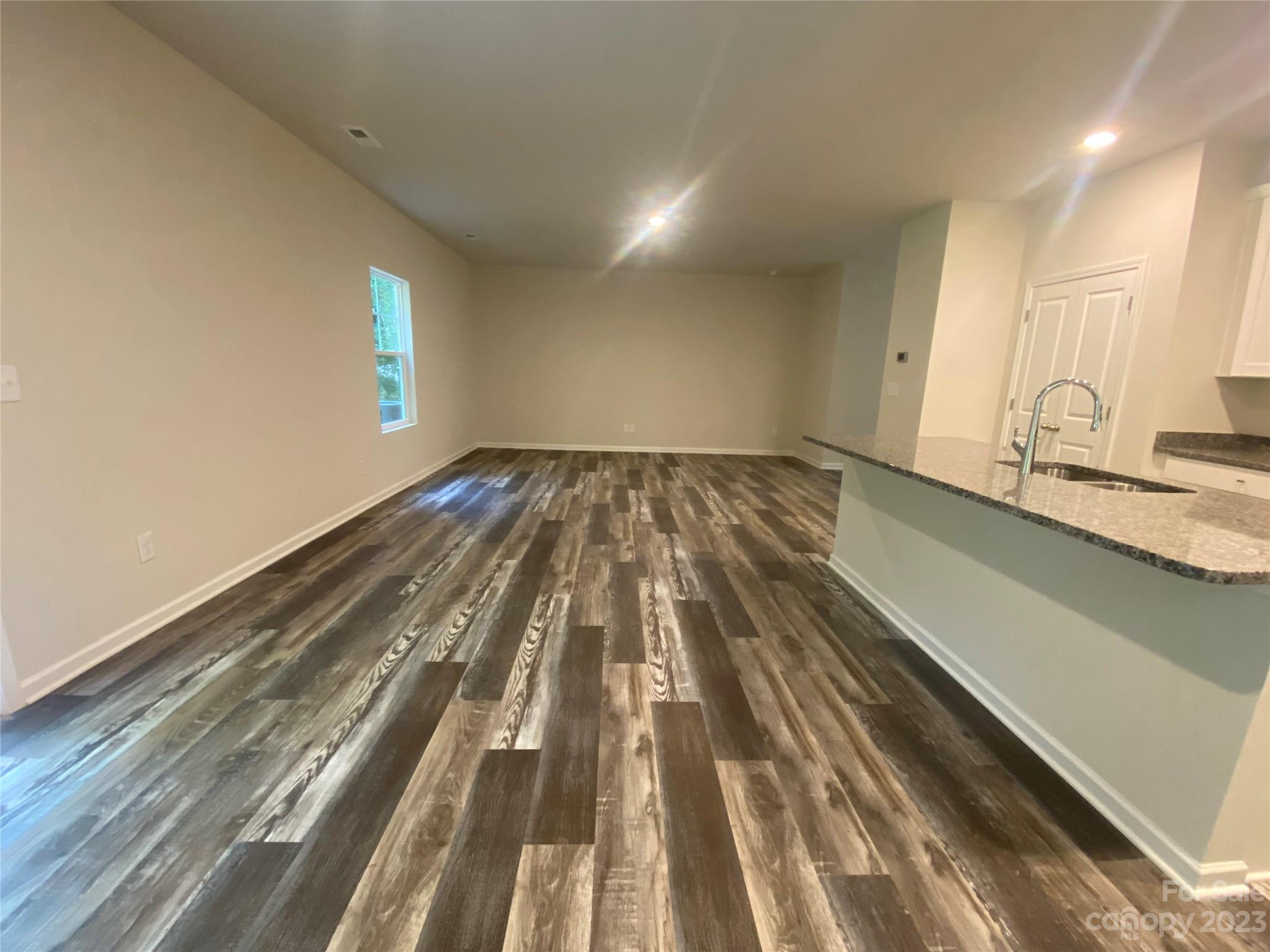 2903 Allen Road South Charlotte, NC 28269 - Photo 4 of 12 a view of a room with wooden floor and staircase