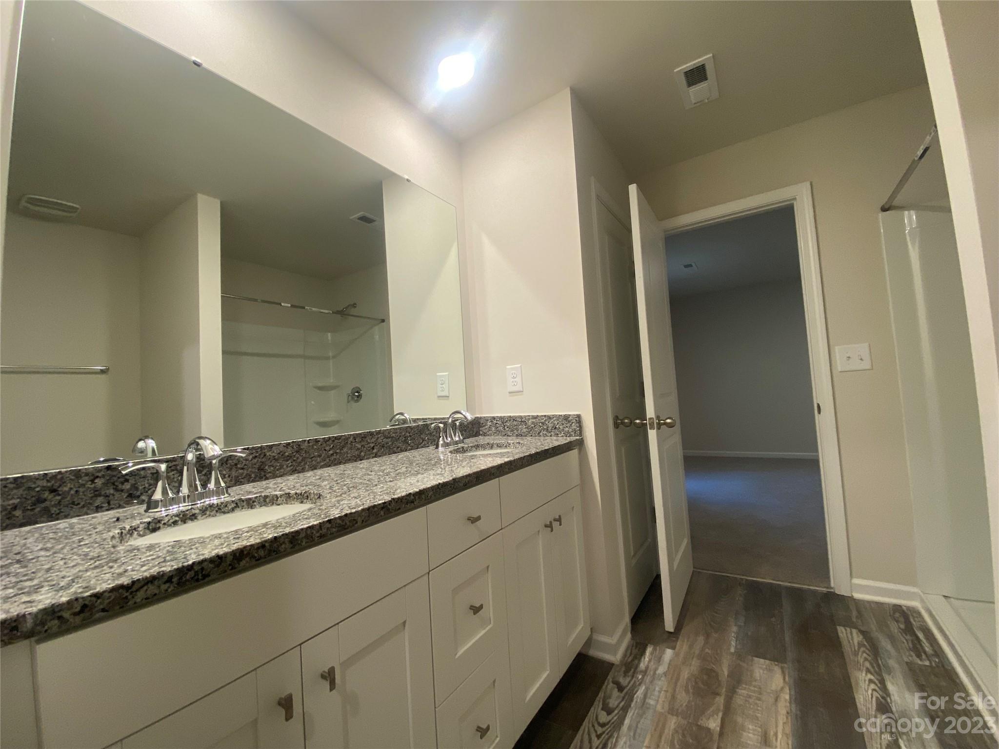 2903 Allen Road South Charlotte, NC 28269 - Photo 7 of 12 a bathroom with a granite countertop sink and a mirror