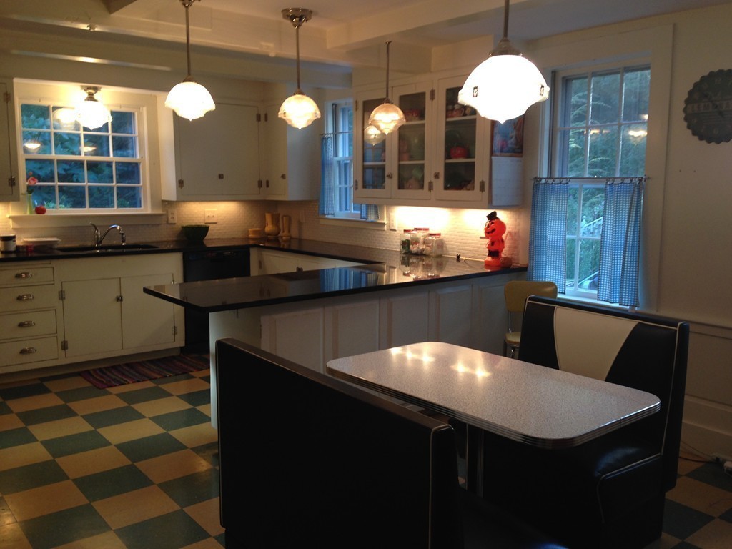 78 River Road Merrimac, MA 01860 - Photo 5 of 21 a kitchen with a table chairs and a stove
