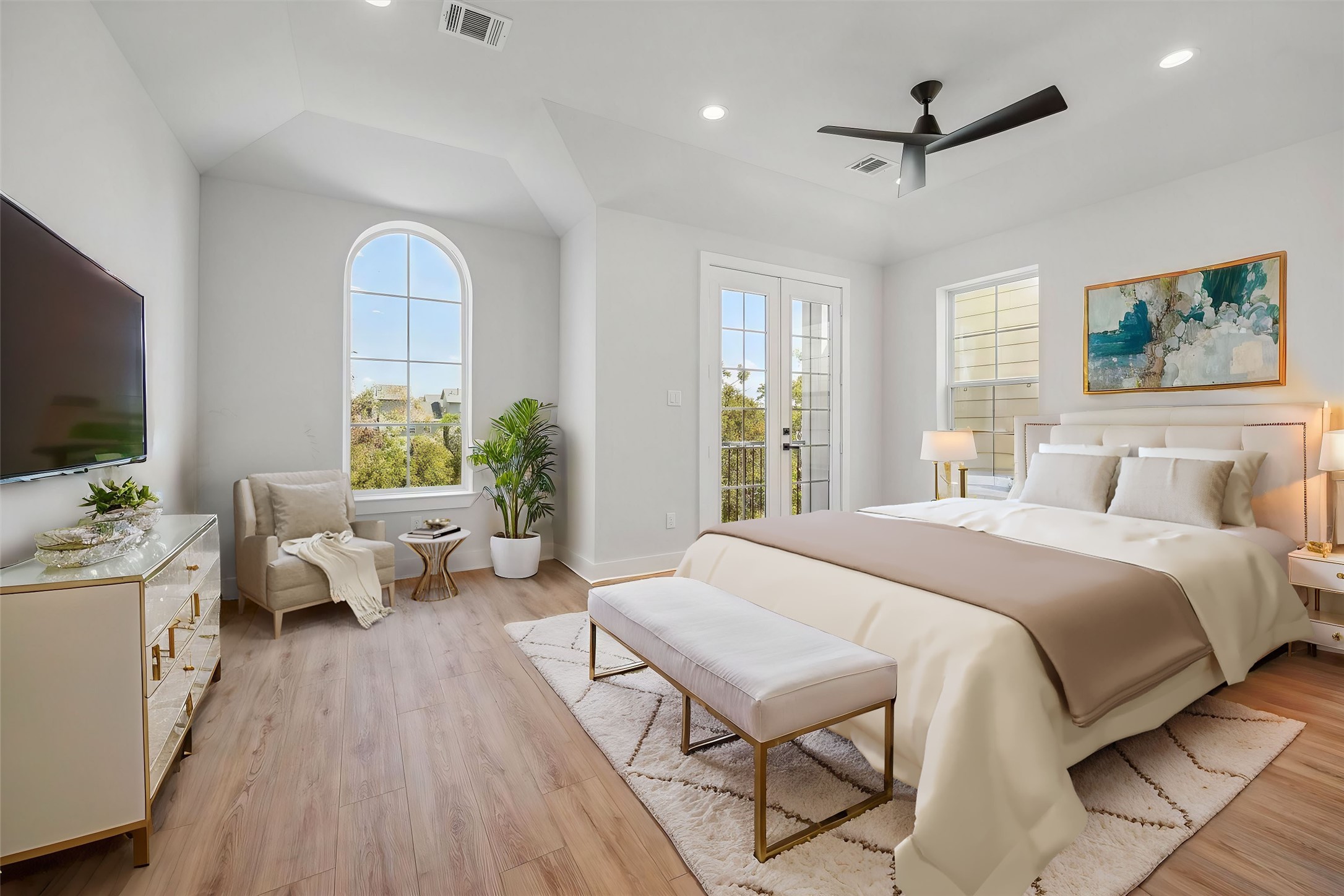 a spacious bedroom with a large bed and a flat screen tv