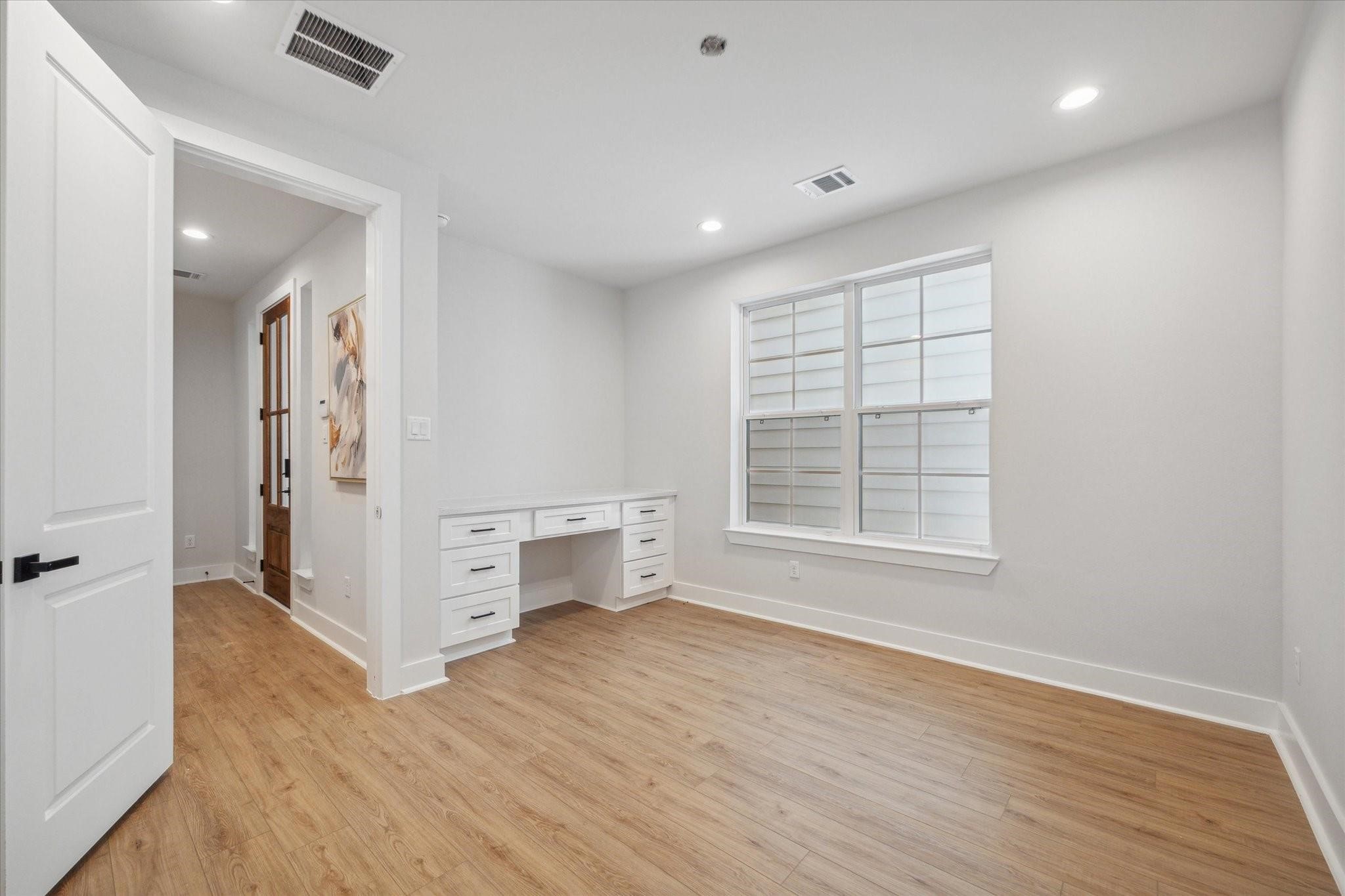 1035 West 17th Street Houston, TX 77008 - Photo 14 of 26 an empty room with wooden floor and windows