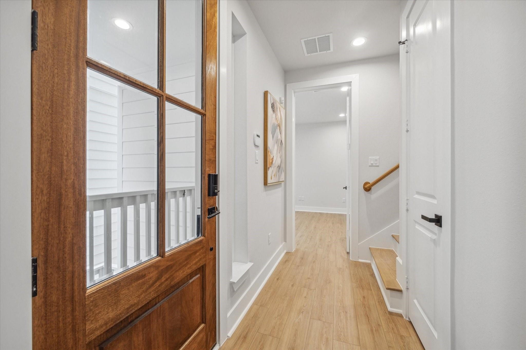 1035 West 17th Street Houston, TX 77008 - Photo 3 of 26 a view of a hallway with wooden floor and staircase