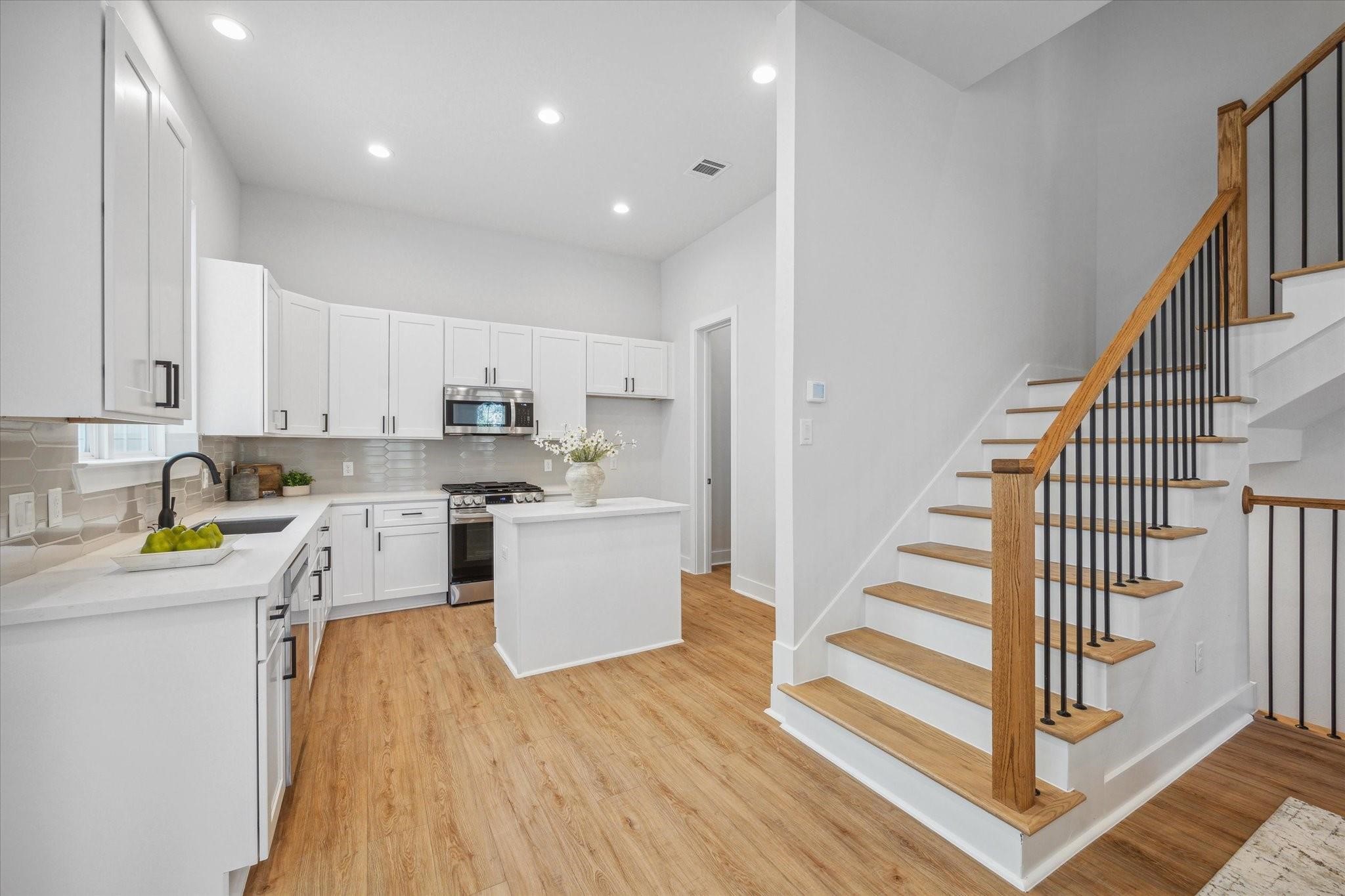 1035 West 17th Street Houston, TX 77008 - Photo 8 of 26 a kitchen with cabinets and wooden floor