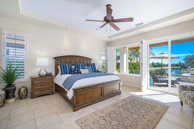 a bedroom with a bed a table and chair