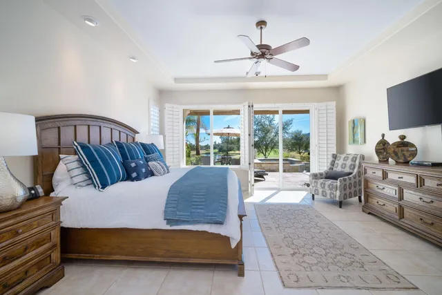 a bedroom with furniture and large windows