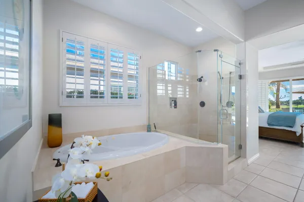 a spacious bathroom with a tub sink and shower