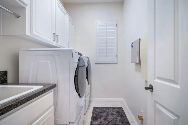 a view of a patio with table and chairs under an umbrella