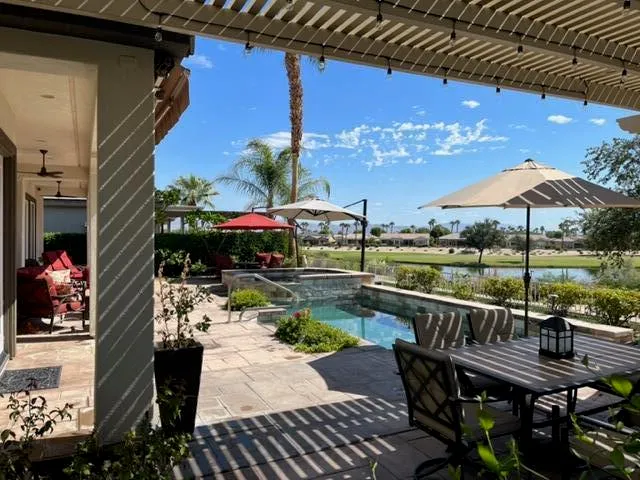 a view of a balcony with two chairs and a table