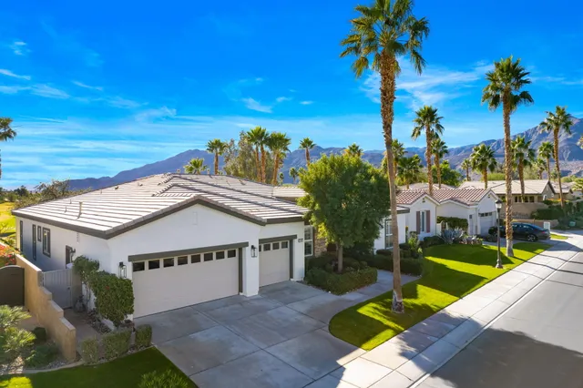 a view of a house with pool and a yard