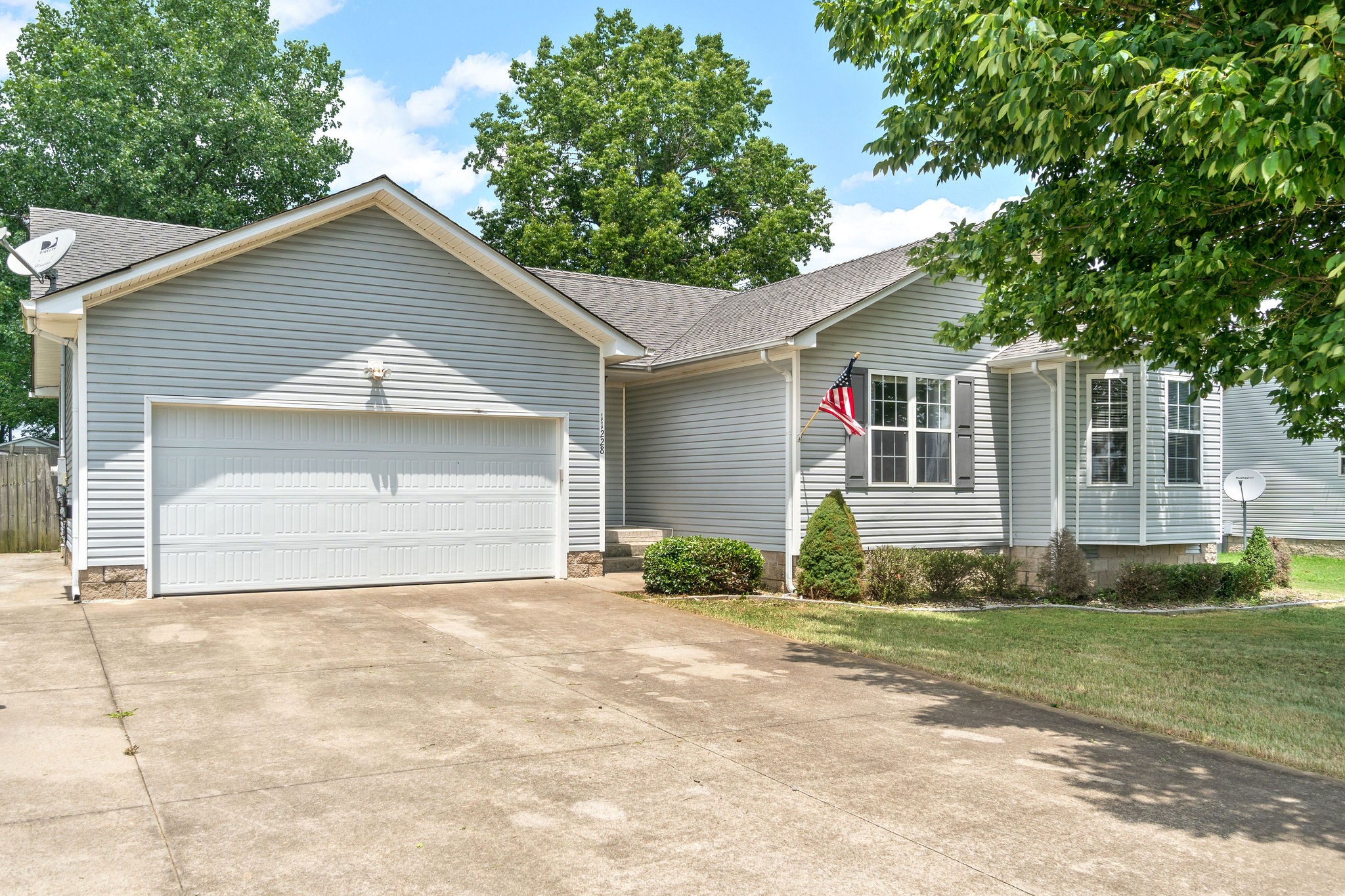 11228 Bell Station Road Oak Grove, KY 42262 - Photo 1 of 1 a front view of a house with a yard and garage