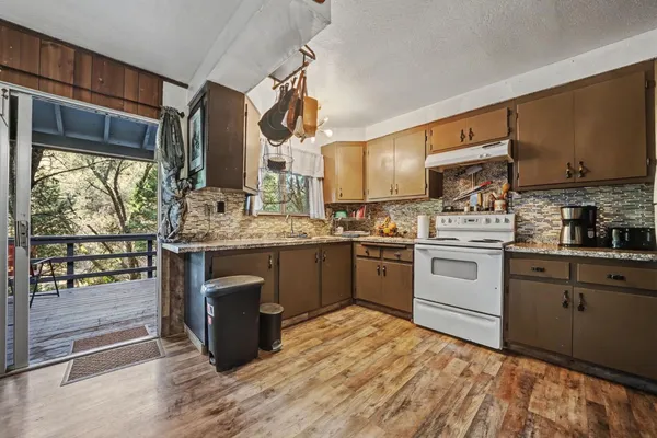 a living room with furniture and kitchen view