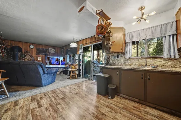 a living room with furniture a flat screen tv and a floor to ceiling window