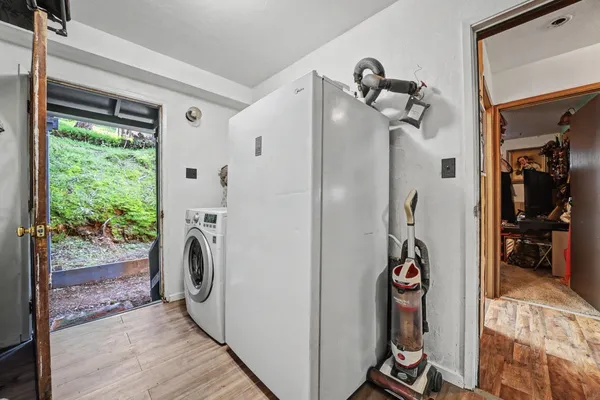 a view of a hallway with wooden floor and staircase