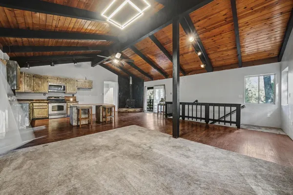 a kitchen with stainless steel appliances granite countertop a stove sink and cabinets