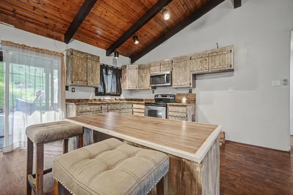 a spacious bedroom with a bed and a large window